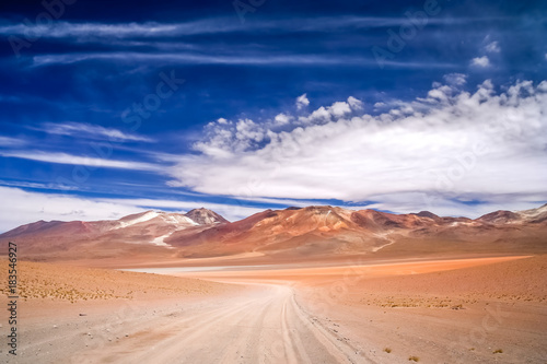 Sandy and gravel desert road through Altiplano