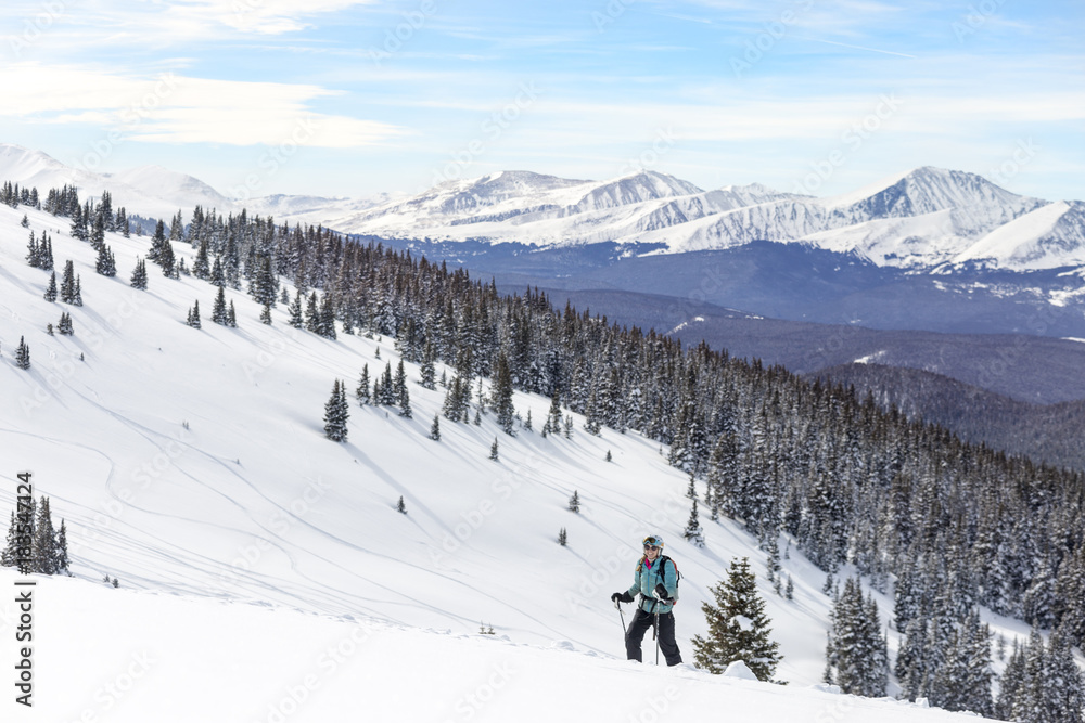 Woman skiing against snowcapped mountains Woman skiing against snowcapped mountains