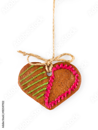 Gingerbread on rope in the form of heart - Christmas homemade sweet cookie, isolated on white background