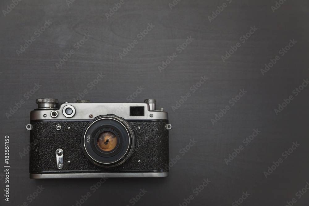 Vintage Film Camera On Black Wooden Background Technology Development Photographer Concept with copy space. Top View