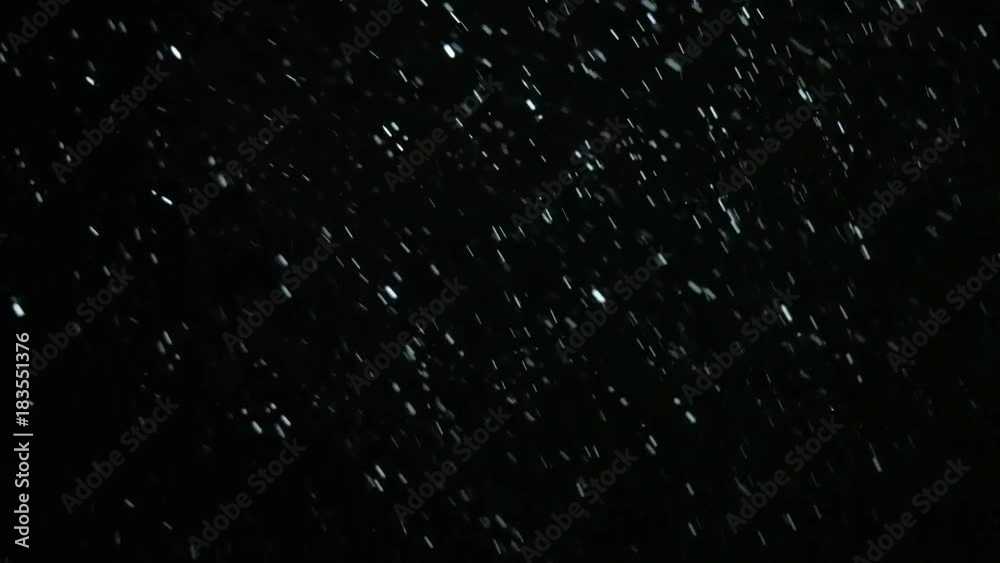 On a black background Snow falls and whirls On a black background Snow falls and whirls