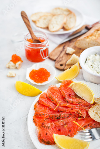 Delicious lunch with salted salmon  red caviar  fresh bread and cream cheese