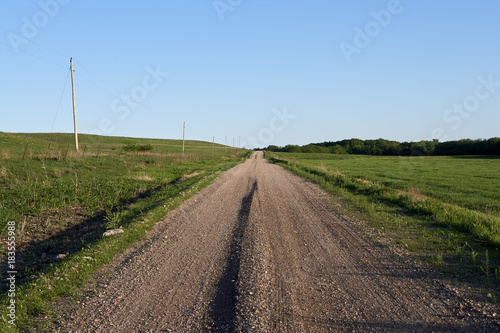 Rural dirt road with electricity poles