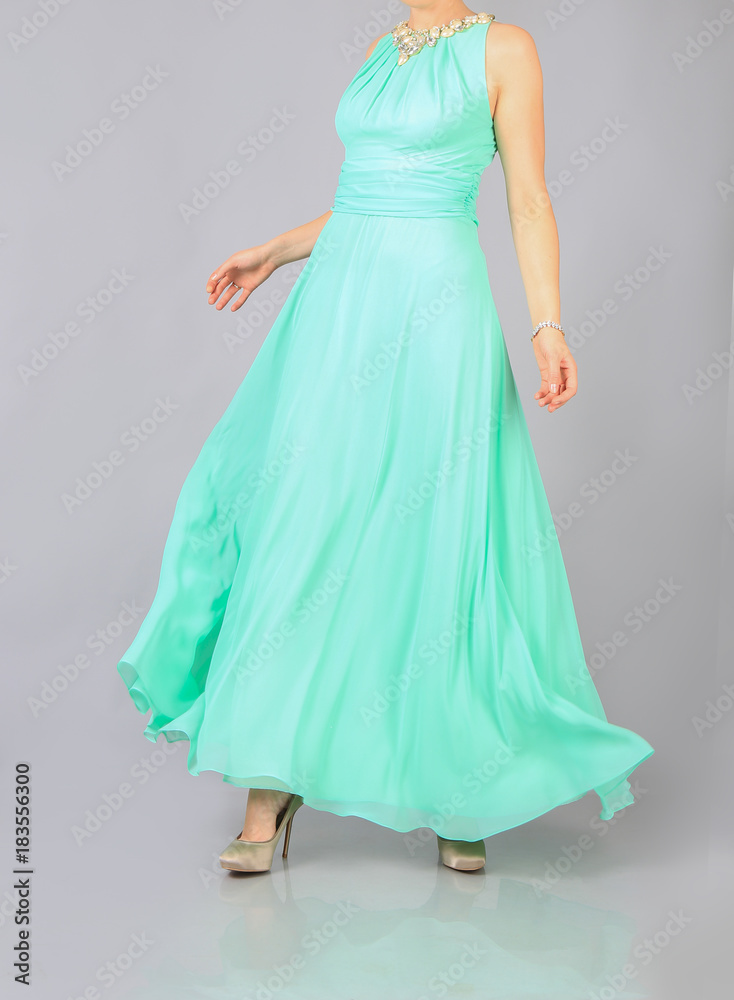 Fototapeta premium long green dress and clutch the girl in studio