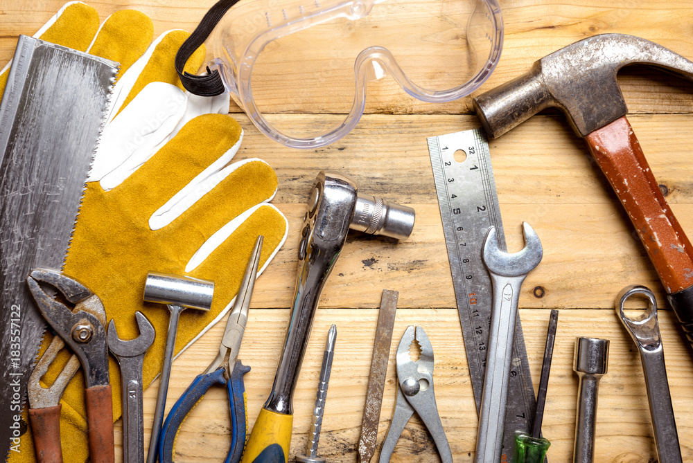 Assorted work tools on wooden board - DIY concept Assorted work tools on wooden board - DIY concept