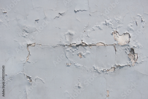 The texture of the cracked wall with the stucco plaster on the brick