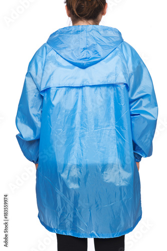 Young woman is wearing blue raincoat with hood isolated on white background