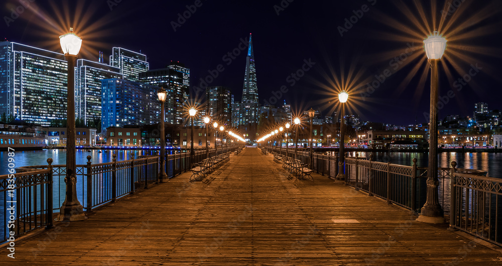 Downtown San Francisco and the Transamerica Pyramid at Christmas from wooden Pier 7 at sunset