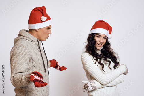 a man looks at a woman incomprehensibly, a couple, a new year, a holiday, emotions photo