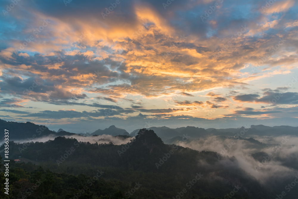 Fototapeta premium Mountain view with foggy environment during sunrise