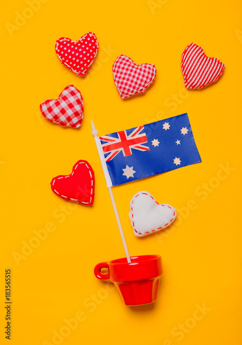 Red cup with heart shapes and flag of Australia © Masson