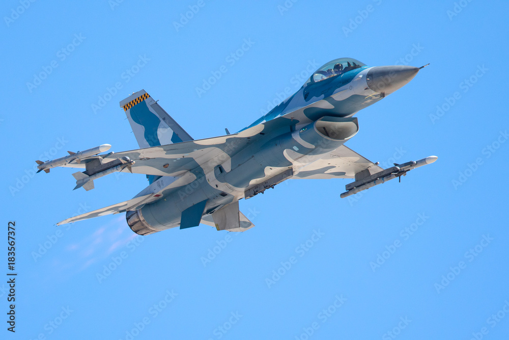 F-16 Fighting Falcon at a very unusual close view, with afterburners on and missiles on wingtips F-16 Fighting Falcon at a very unusual close view, with afterburners on and missiles on wingtips