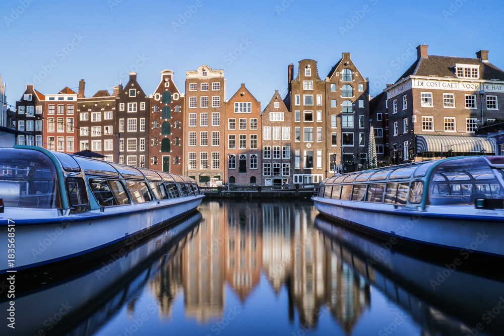 Canal boats and traditional Amsterdam buildings