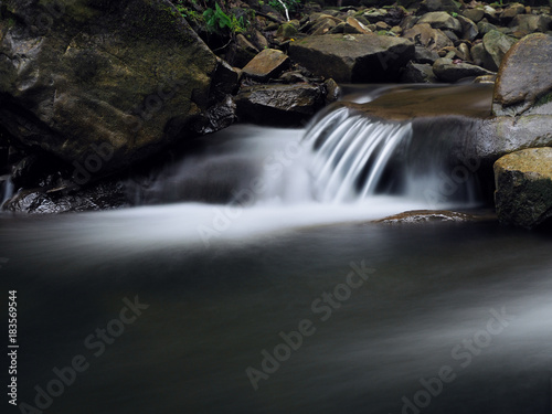 Waterfall at the carpatian mountains green forest