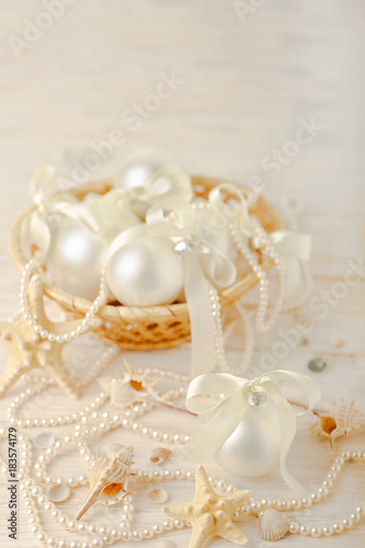 Christmas and New Year. Christmas-tree white toys in a marine style  seashells stones and starfish.