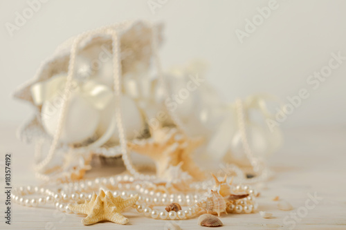 Christmas and New Year. Christmas-tree white toys in a marine style, seashells stones and starfish.