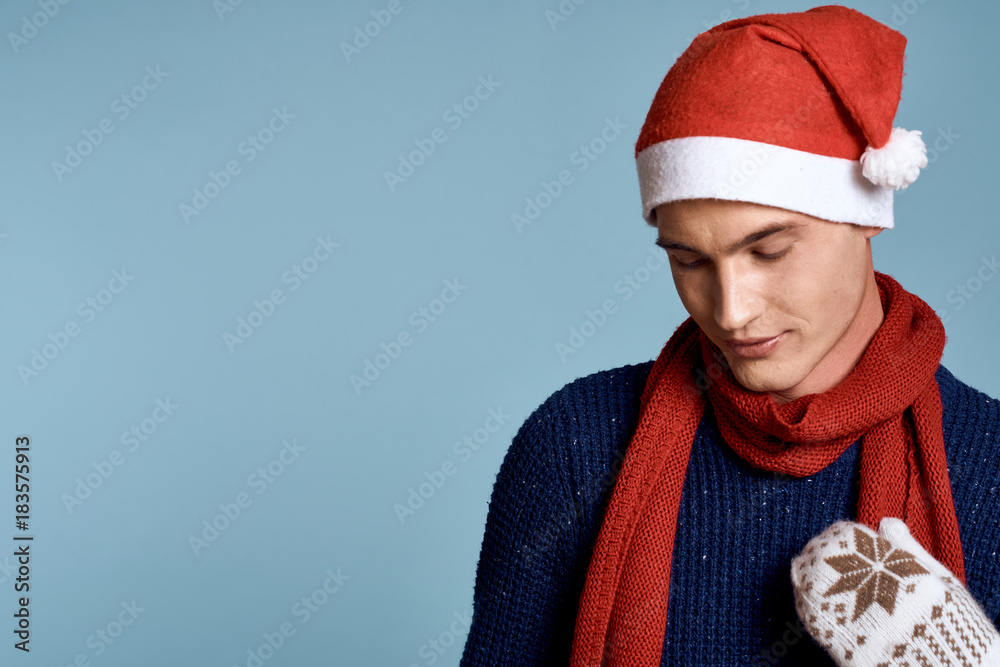 man in mittens looking down, light blue background, free space for copy, christmas, holiday, new year man in mittens looking down, light blue background, free space for copy, christmas, holiday, new year