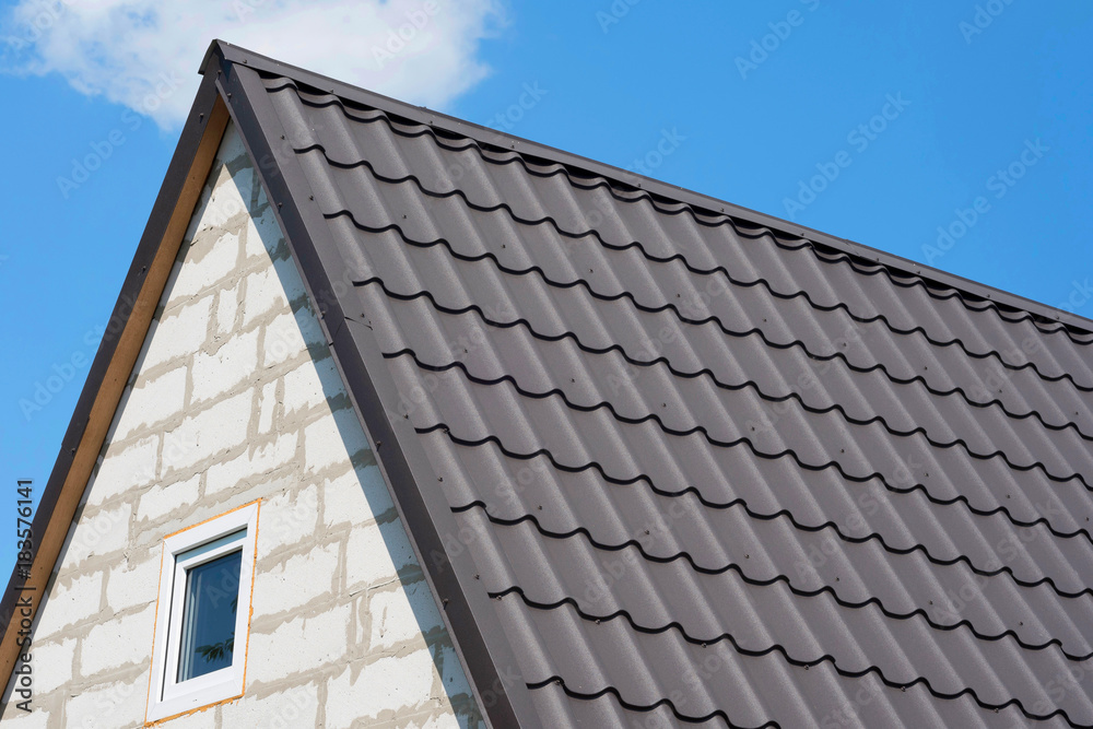 Roof of the house under brown shingles