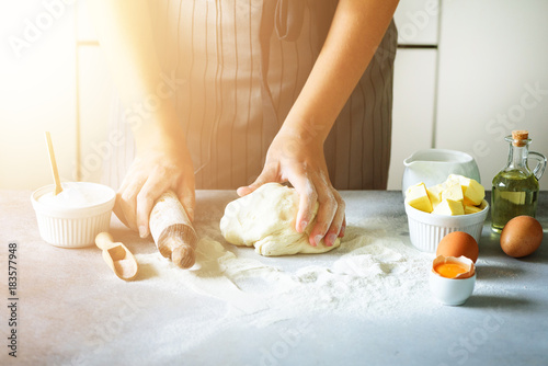 Heart of flour. Baking background with rolling pin, eggs, milk, butter on white kitchen table. Valentines day cooking, love concept.