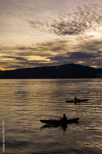 Sunset Sunrise with reflections at Lake Toba, Samosir Island, Indonesia. © khlongwangchao