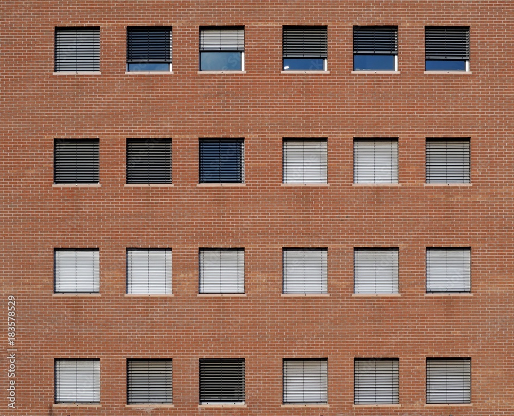 Brick wall facade of a modern building with square windows