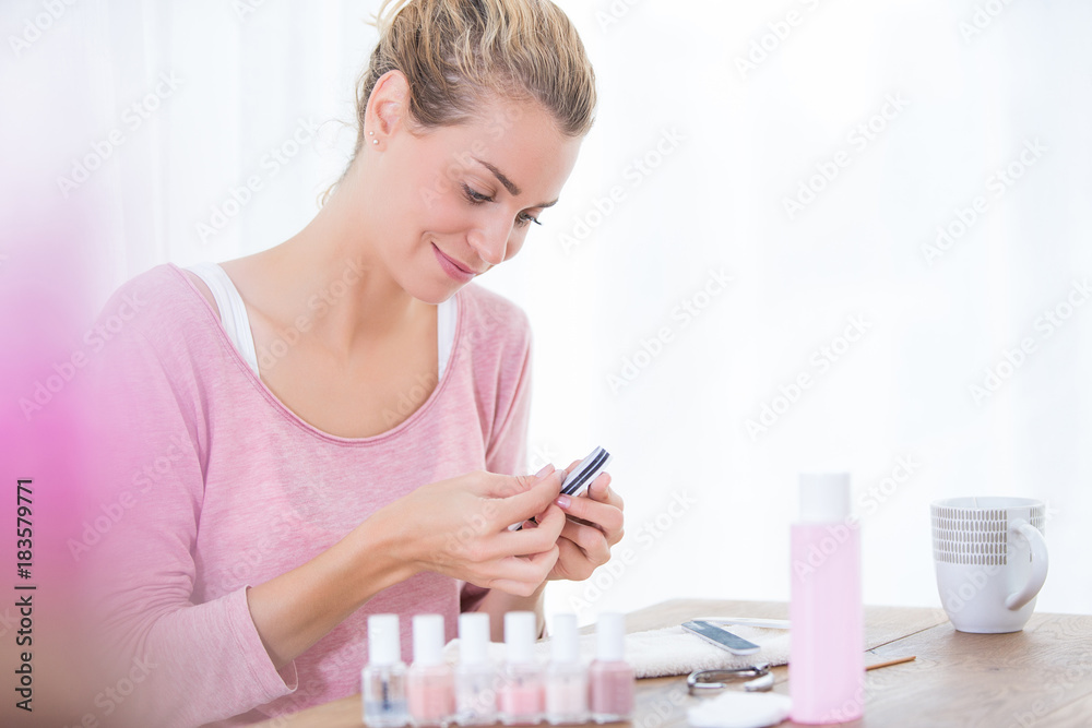 woman doing french manucure at home woman doing french manucure at home