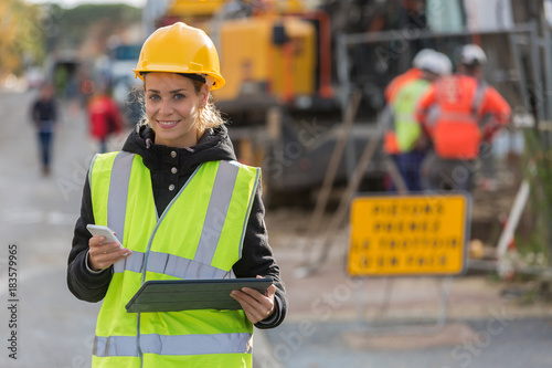 female construction woman using electronics on construction site