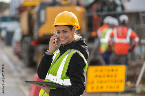 female construction woman using electronics on construction site