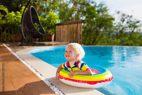 Baby in swimming pool. Kids swim. Child summer fun. © famveldman