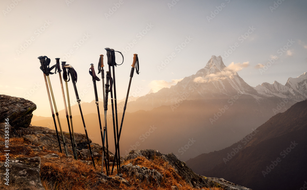 Trekking sticks on mountain top background - obrazy, fototapety, plakaty 