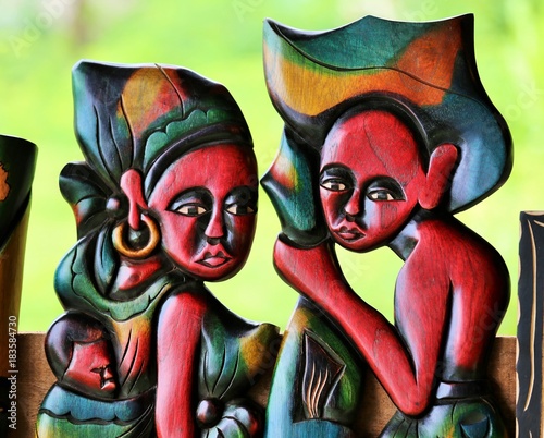 detail of a wooden colored statue representing a couple with a baby in sao tome and principe