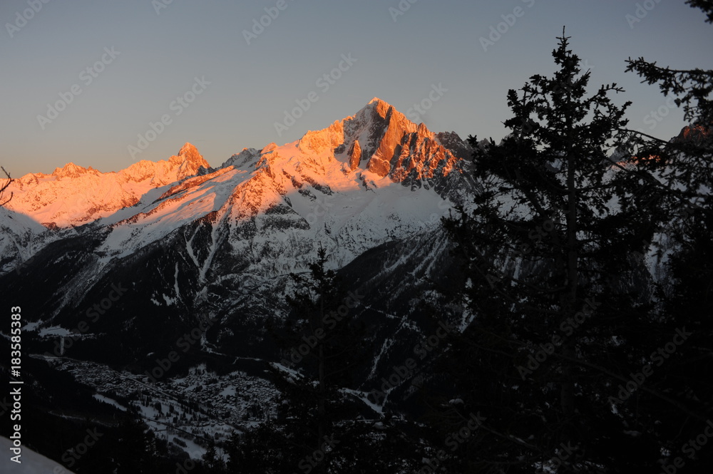 French Alps during sunset with a village in the valley
