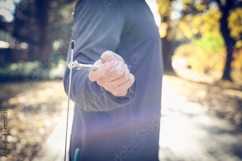 Man hand holding jump rope. Close up. © liderina