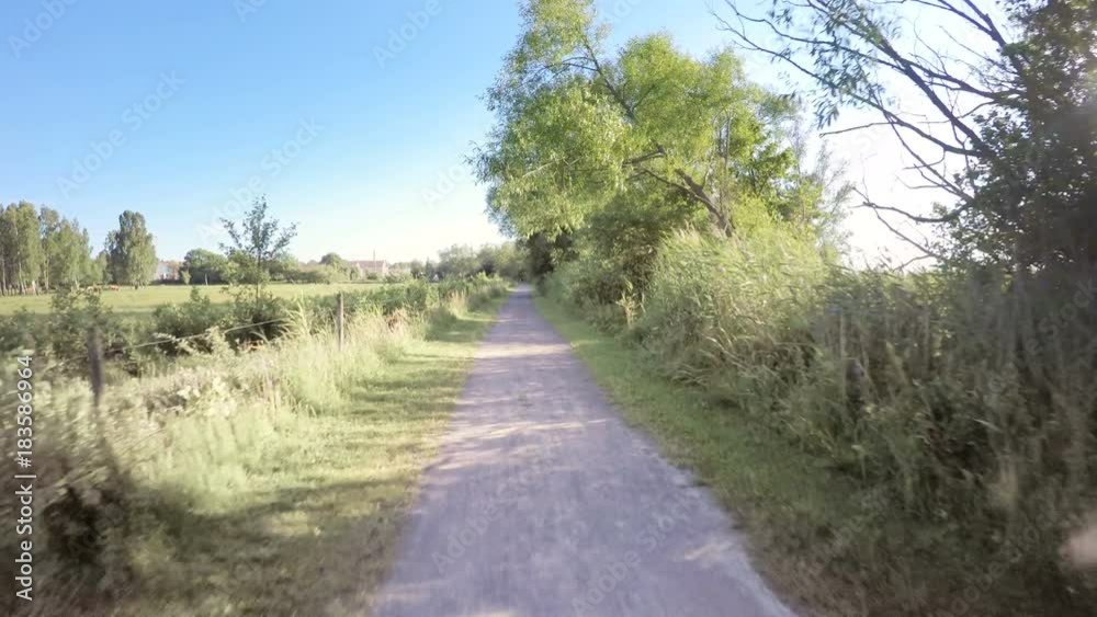 Riding bike on rural road, pov action film clip in fast motion. Adventure and sports in nature. Riding bike on rural road, pov action film clip in fast motion. Adventure and sports in nature.