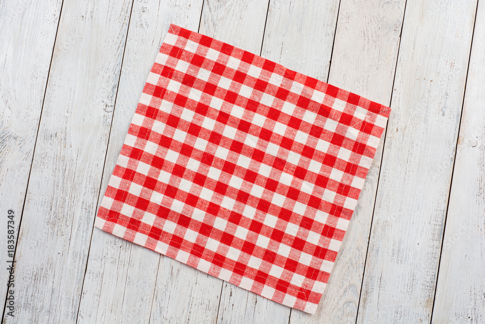 Red tablecloth on white wooden table background. Red tablecloth on white wooden table background.