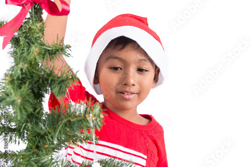 Cute little boy with decorating Christmas tree
