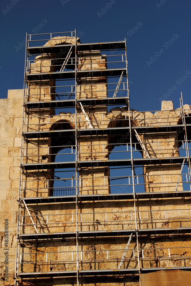 Scaffolding on the exterior walls of the Odeon of Herodes Atticus, Athens, Greece during restoration process.