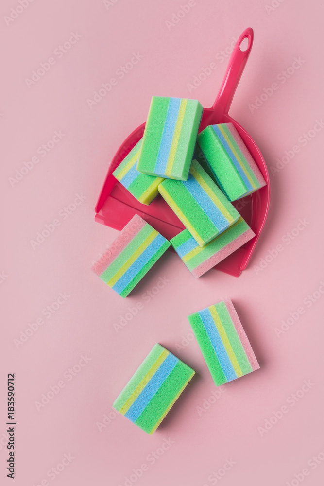 top view of colorful washing sponges in scoop, isolated on pink top view of colorful washing sponges in scoop, isolated on pink