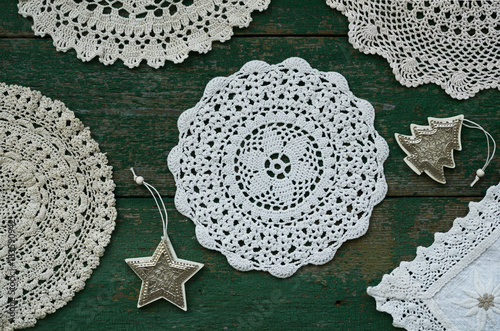 Set of vintage lace doilies and Christmas toys on rustic background