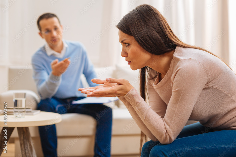 Exit from situation. Depressed unhappy female patient resenting about her life sitting in profile  while  placing  elbows on her knees 