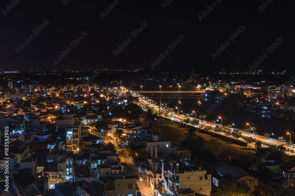 part of the night city of Nha Trang, the Kai river, in the light of street lights, Vietnam
