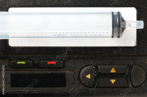Old and dirty pager in the scene have syringe at the screen also.