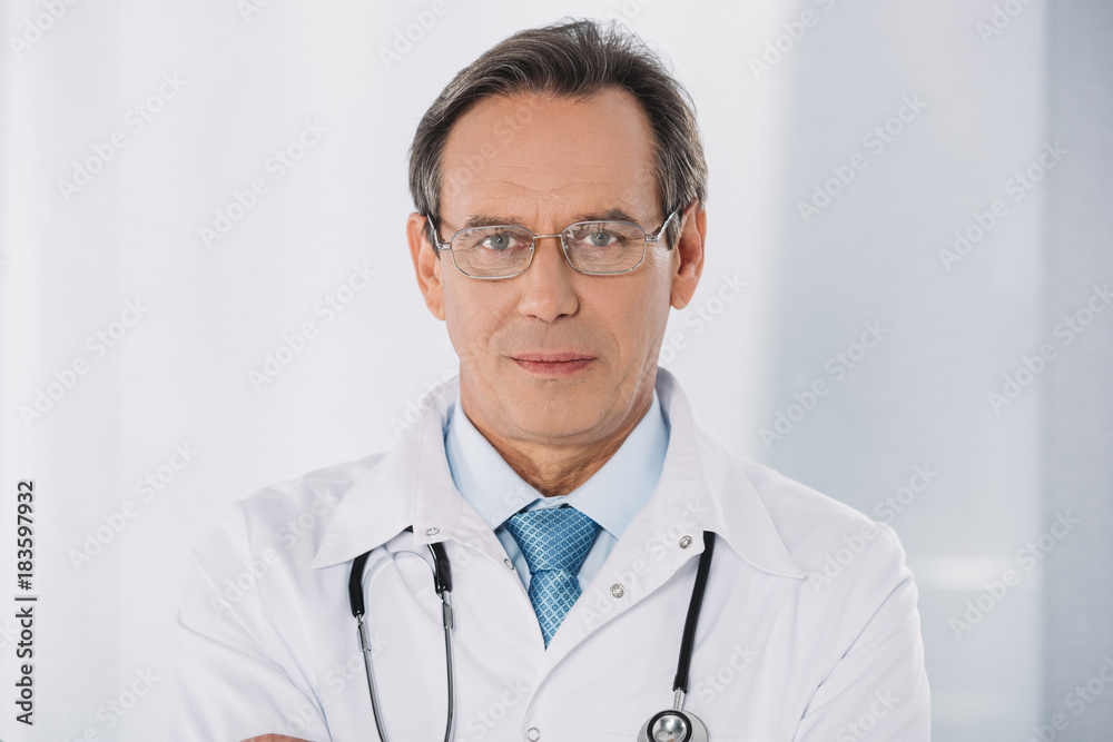 portrait of doctor standing and looking at camera portrait of doctor standing and looking at camera