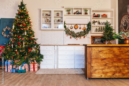 Christmas living room with a Christmas tree, gifts. Dining room. Beautiful New Year decorated classic home interior. Winter background