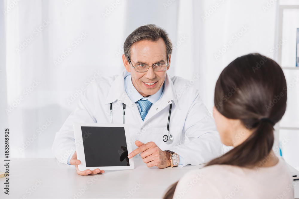 doctor showing something on tablet to female patient doctor showing something on tablet to female patient
