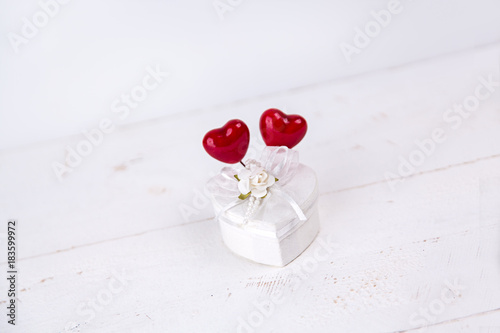 Fototapeta Naklejka Na Ścianę i Meble -  White jewel box with heart shape and red hearts