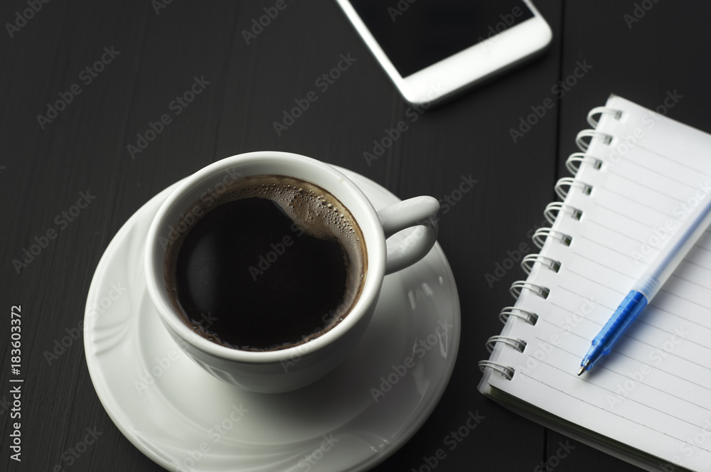 Smartphone with notebook and cup of coffee Smartphone with notebook and cup of coffee