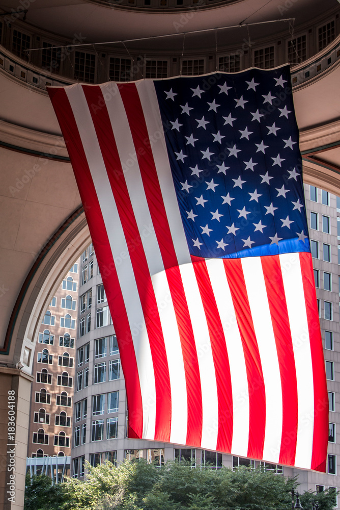 Big US american Stars and Stripes Flag Hanging from inside Dome in Boston Massachusetts on sunny day