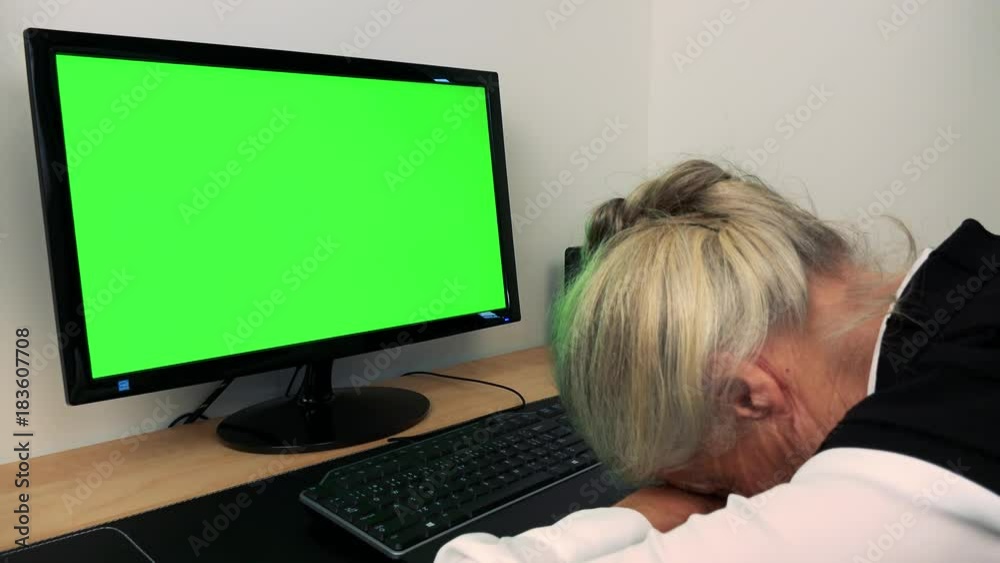 Old caucasian woman sleeps at the computer in home - green screen Old caucasian woman sleeps at the computer in home - green screen