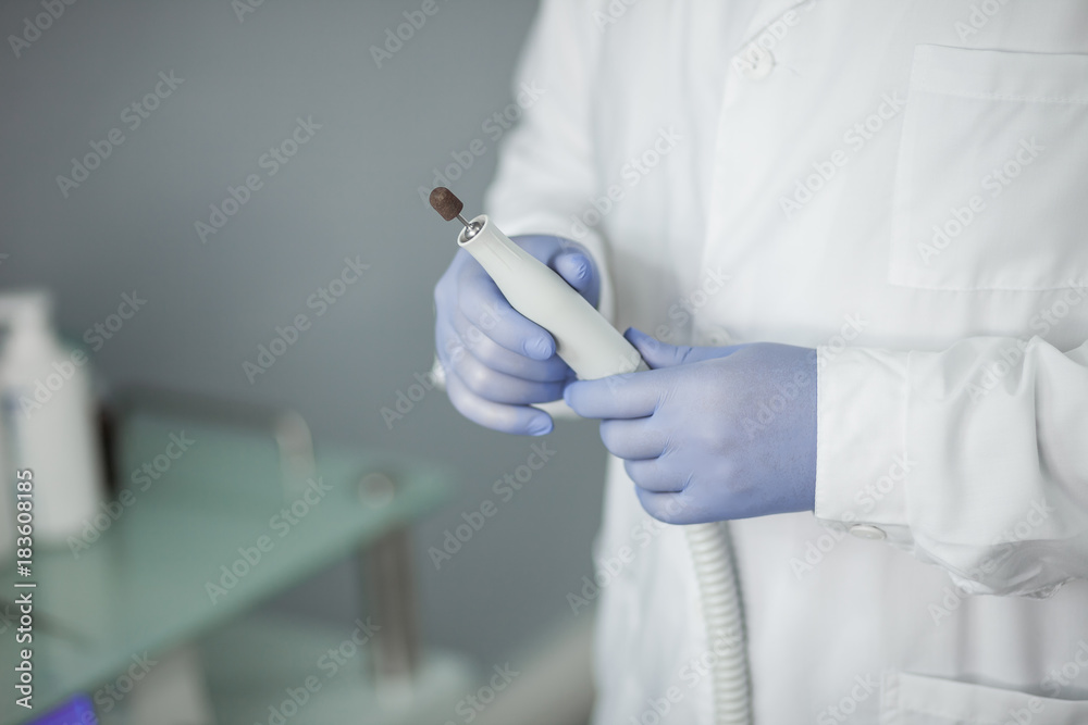 Podiatry doctor. With tools. With milling cutter Podiatry doctor. With tools. With milling cutter